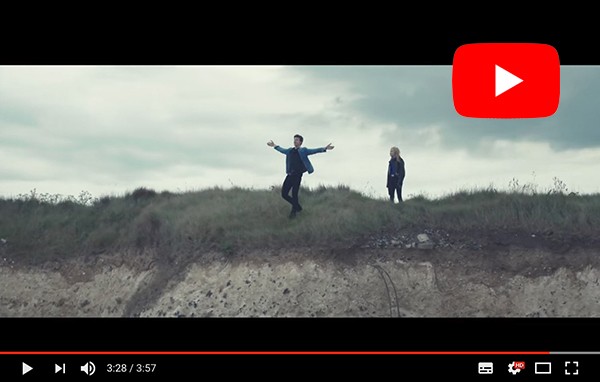 Singer stood on cliff in music video filmed by drone