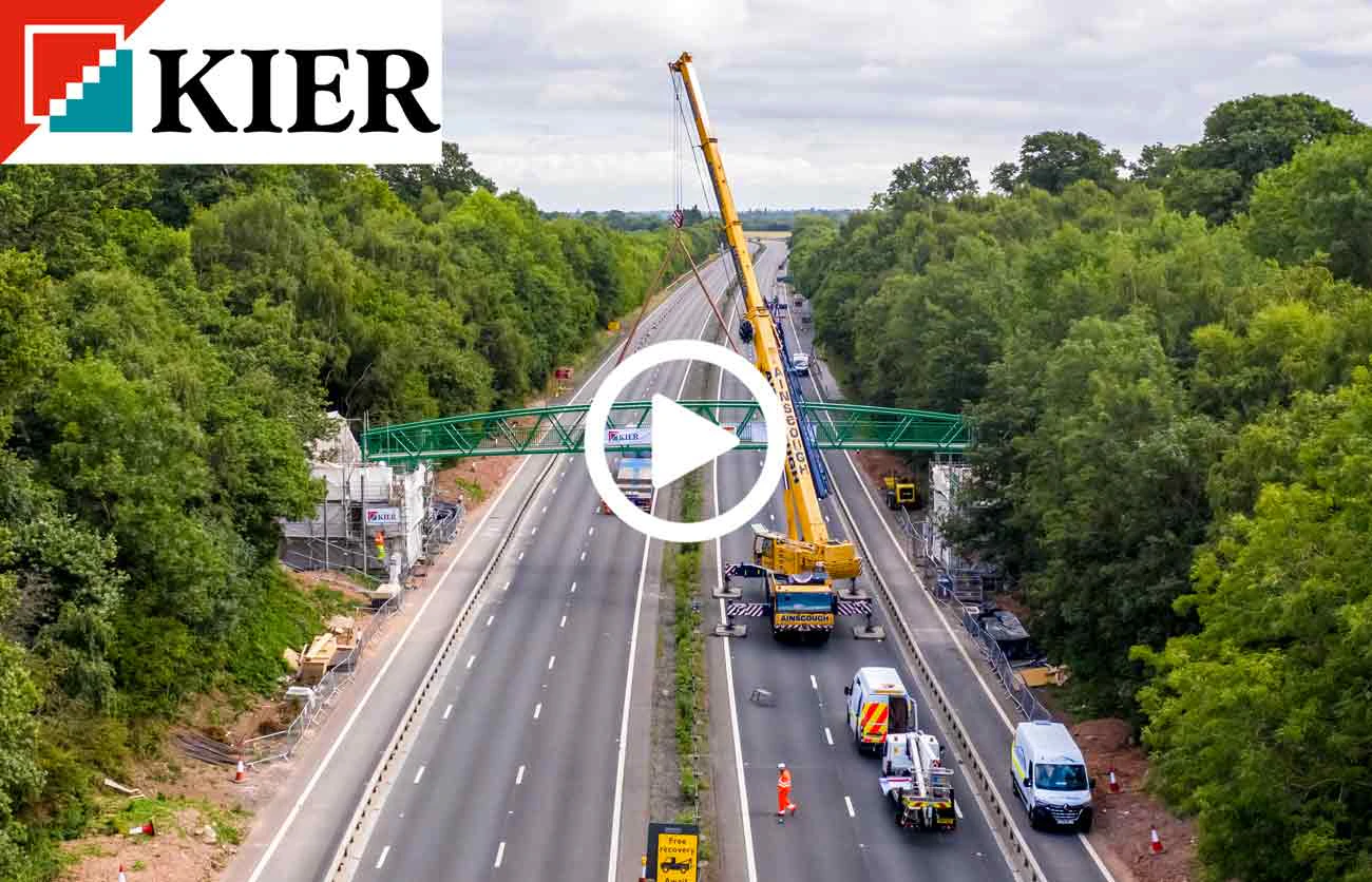 highways bridge being moved by a crane seen from a drone